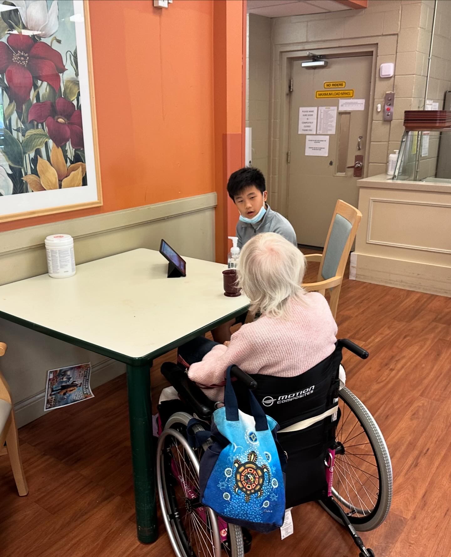 A TechWiseTutors volunteer providing patient one-to-one digital safety support